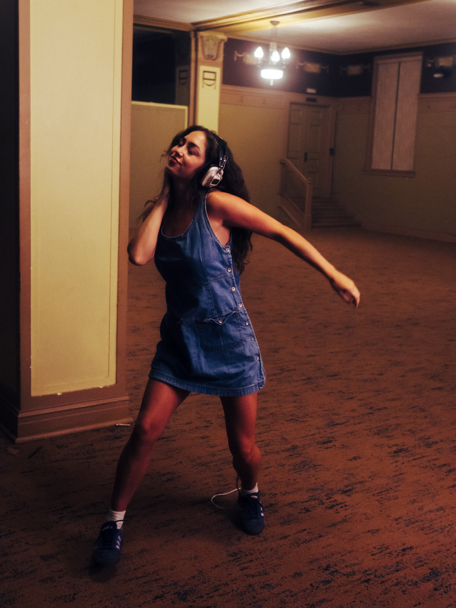 Ella Gross dancing in the ballroom with headphones during HEARTBREAK